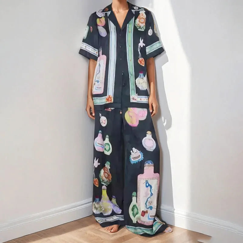 Women's black polyester co-ord set with cartoon animation print showing cardigan and trousers