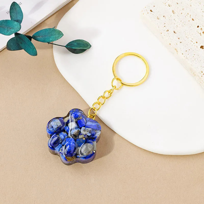 Small handcrafted crystal cat's paw shaped keychain pendant on a keyring.