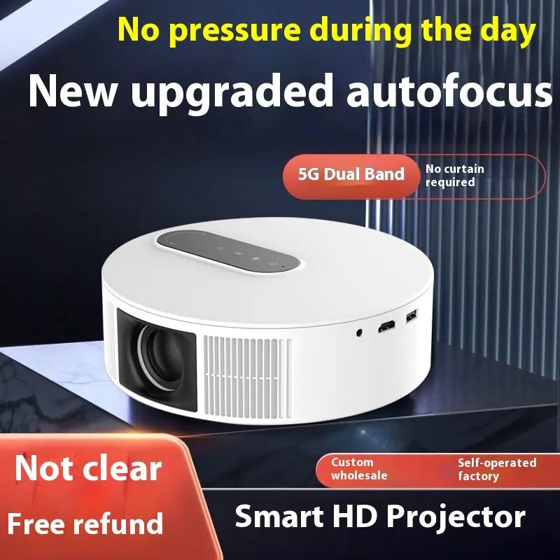 White HD home projector with remote control on a table