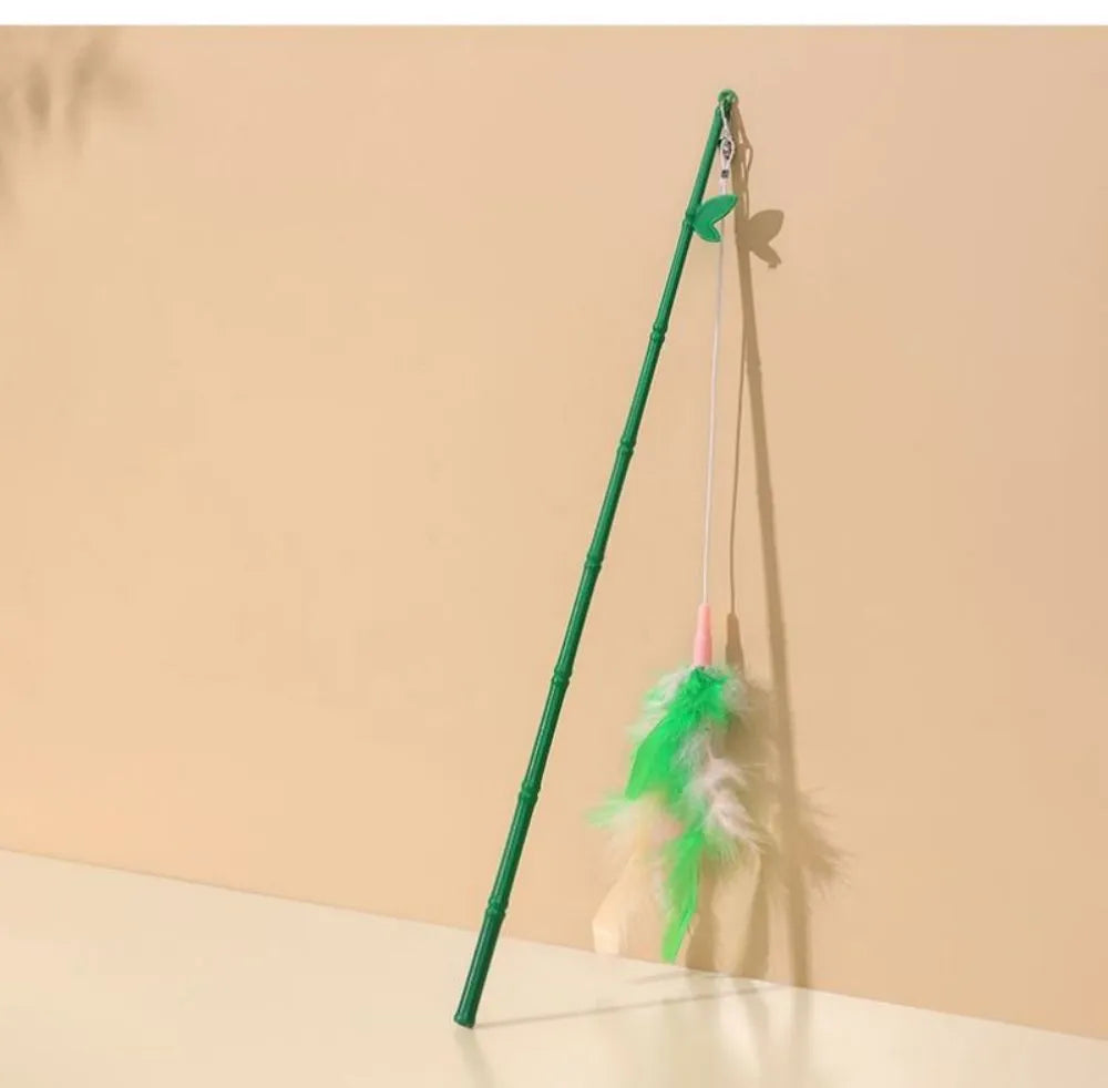 Green cat feather wand toy with bells and feather attachments for interactive feline play