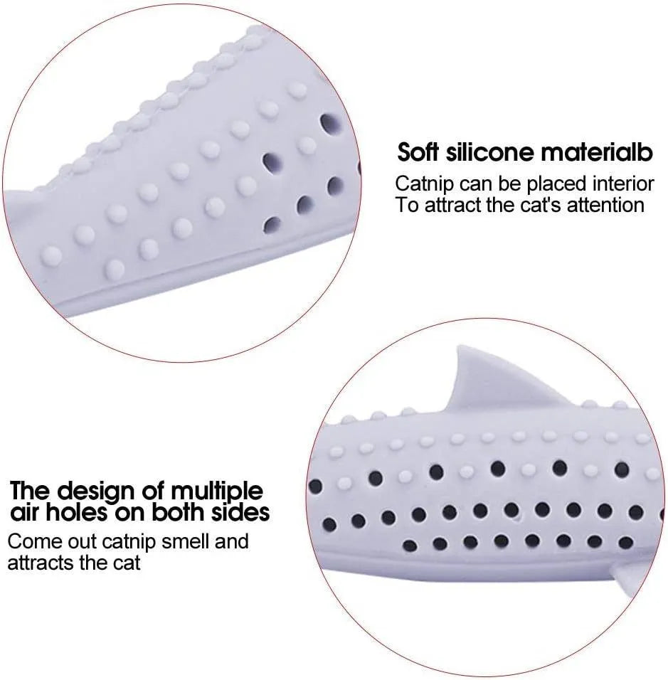 Green silicone fish-shaped cat chew toy with dolphin details and visible side holes.