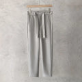 Boys slim straight trousers in wool blend fabric on a hanger, showing tapered leg
