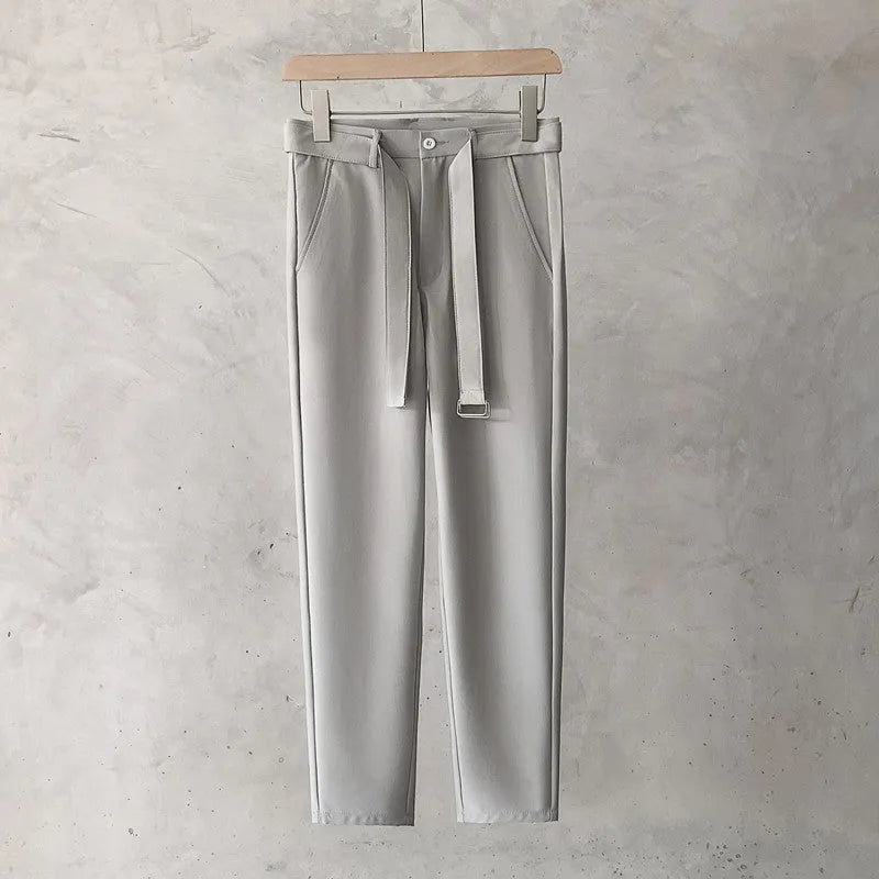 Boys slim straight trousers in wool blend fabric on a hanger, showing tapered leg