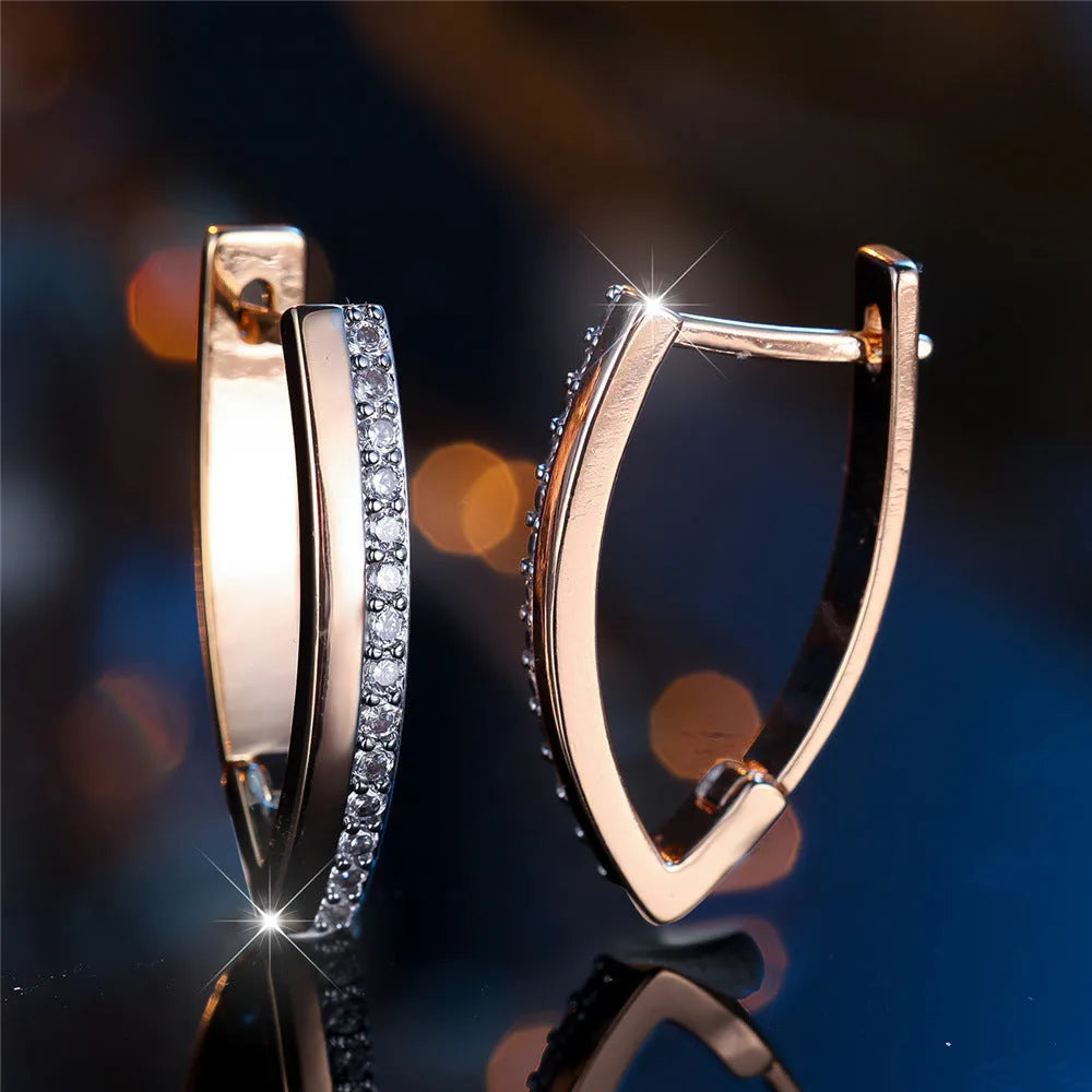 Geometric V-shaped champagne gold women's ear clips with white diamond accents.