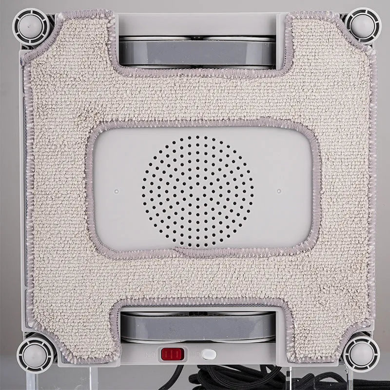White electric window cleaning robot with four water spray jets for automated high-rise window washing