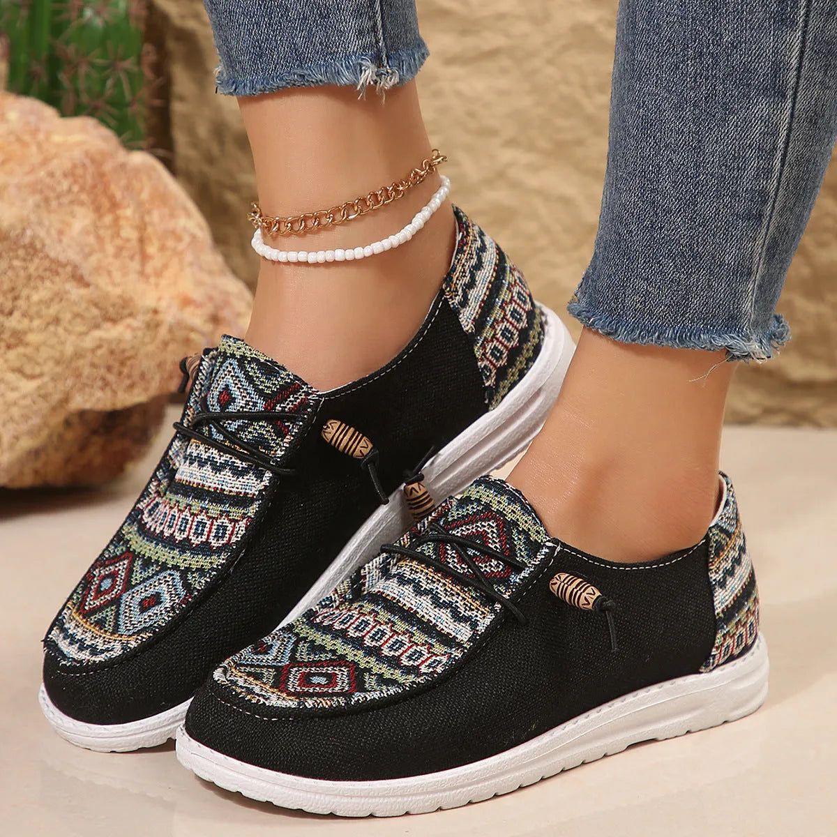 Women's black round toe low-top flat shoes with artificial PU upper and rubber sole on a white background