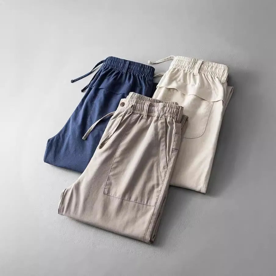 Men's casual linen trousers in retro design showing navy blue, apricot, and grey colour options