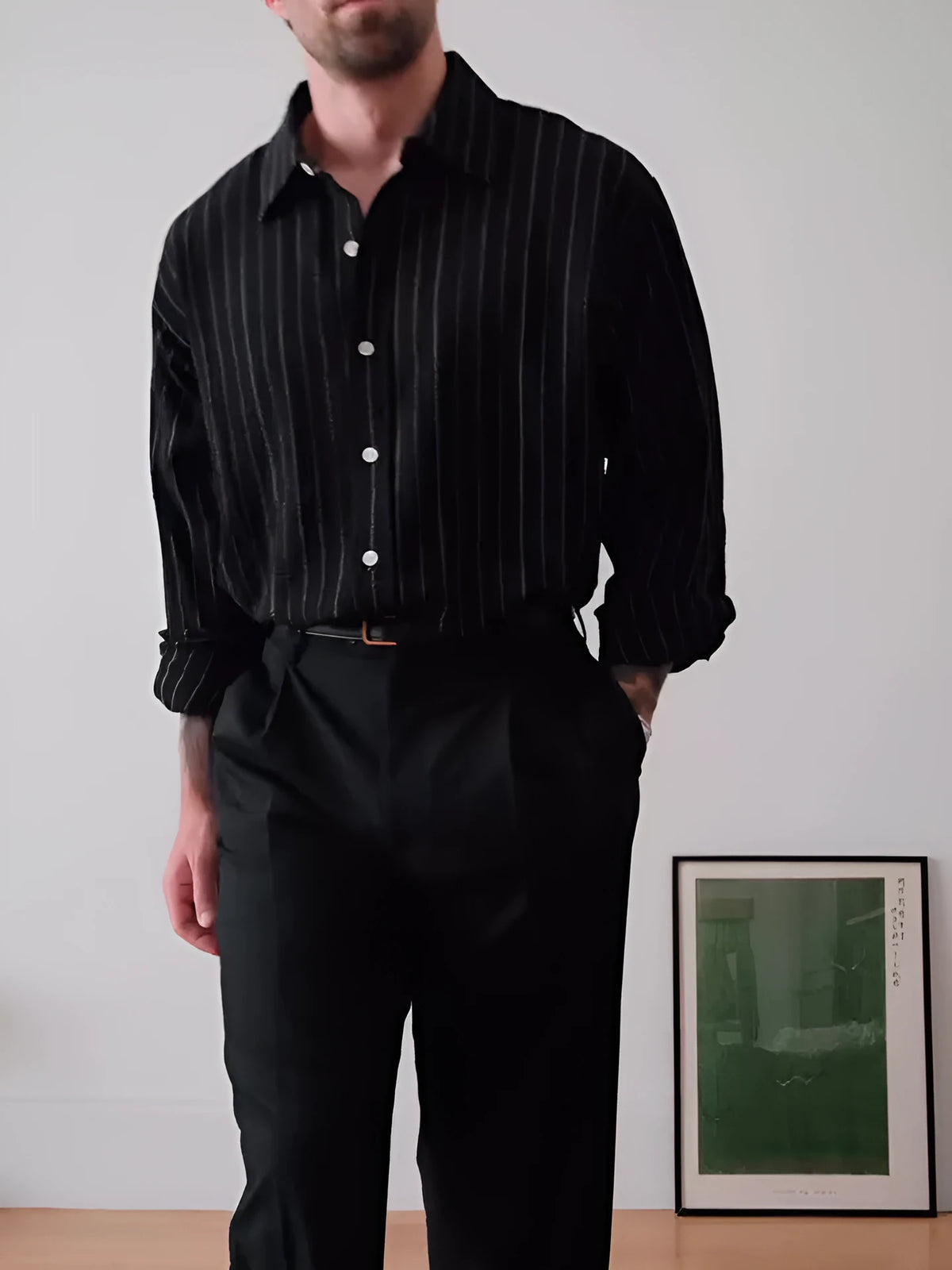 Black pinstripe button-down shirt on hanger showing striped pattern and button front
