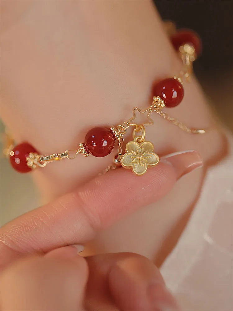 Red agate double layer women's bracelet with carved peach blossom and floral motifs.