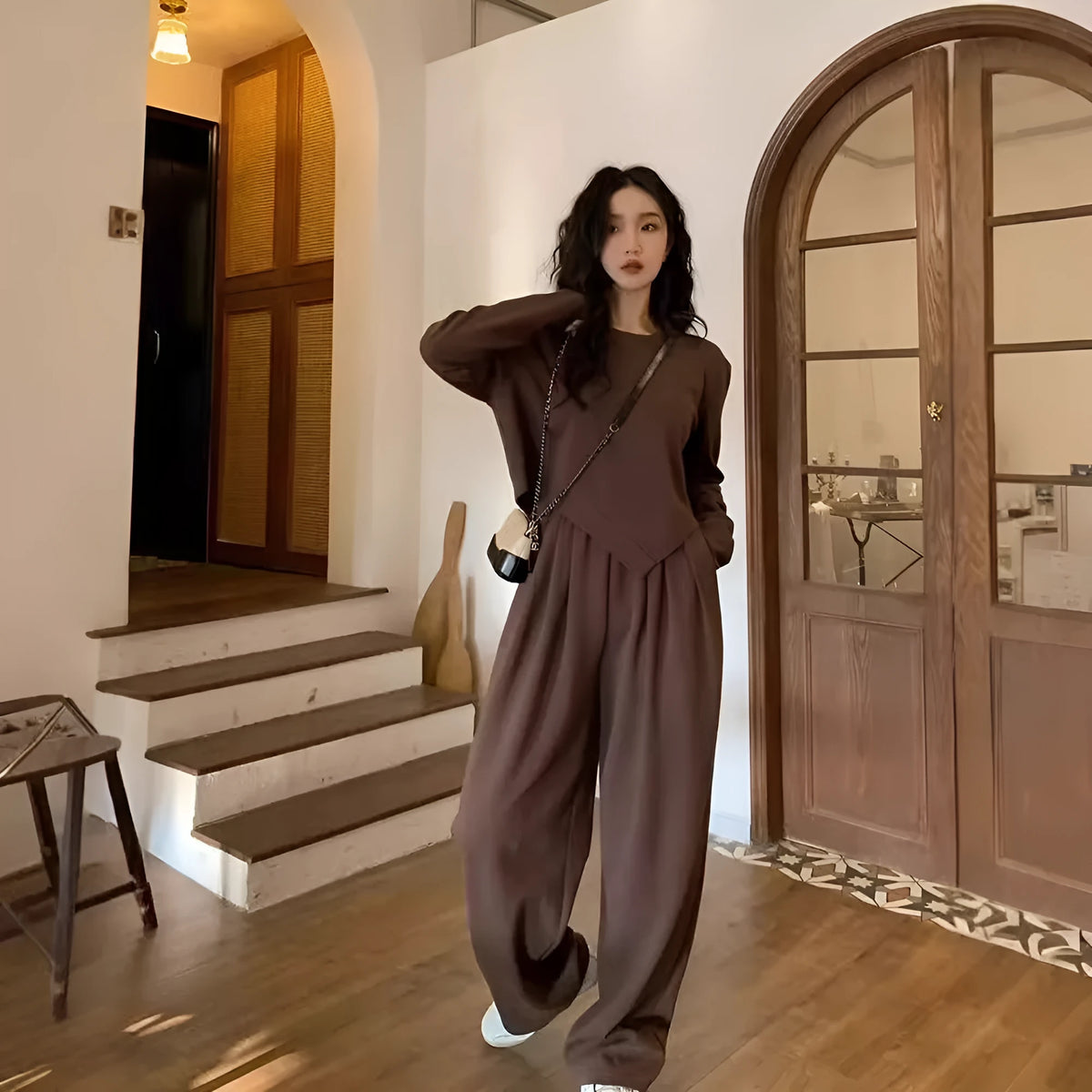 Brown women's loose fit casual sports suit set with long sleeve top and trousers on a model.