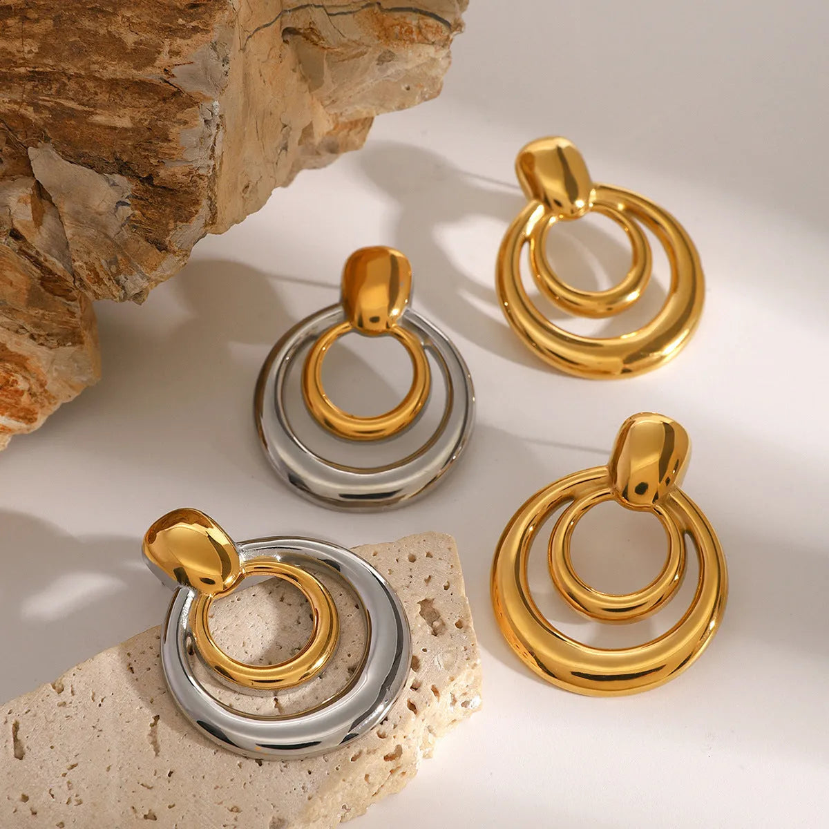 Gold plated double layer hollow stud earrings with round geometric design and titanium steel construction