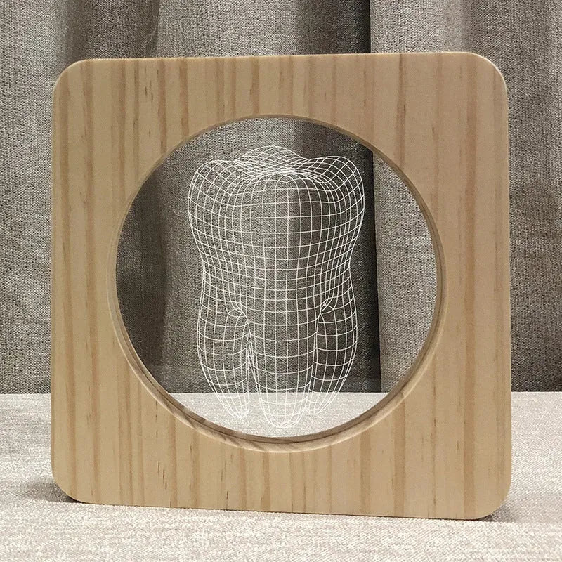 Tooth-shaped wooden-coloured acrylic night lamp with USB cable on wooden surface
