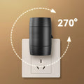 Small white plug-in night light with adjustable dial and rotatable head shown in a UK power socket.