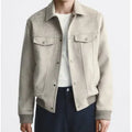 Men's light gray suede velvet commuter jacket with long sleeves on a hanger.