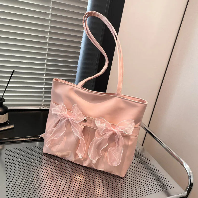 College style bow tote bag in black or pink with double shoulder straps and zippered compartment