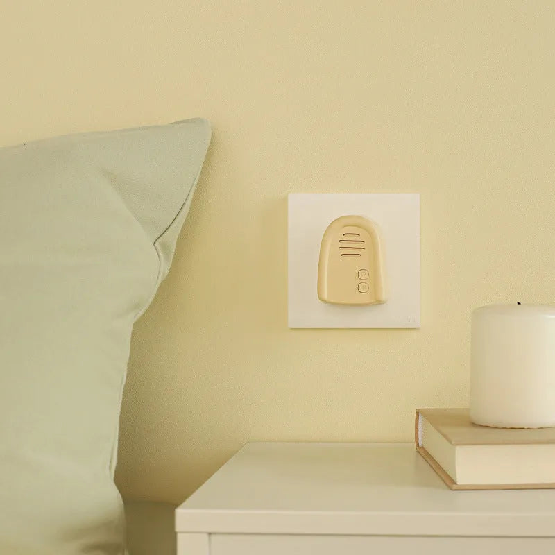 Household wireless plug-in doorbell in milky yellow or white colour