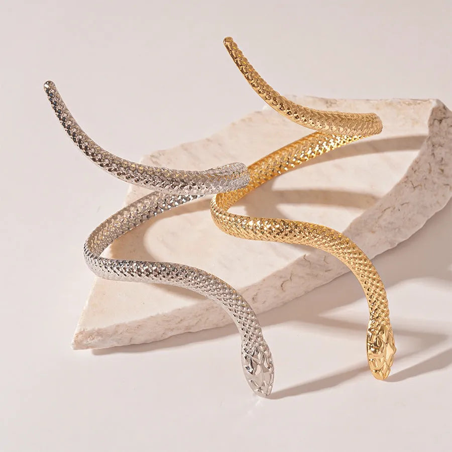 Gold and silver tone snake motif ring and bracelet set with twisted winding design