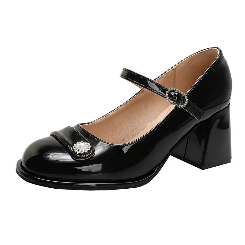 Women's black patent leather chunky heel high shoes with round toe and buckle.