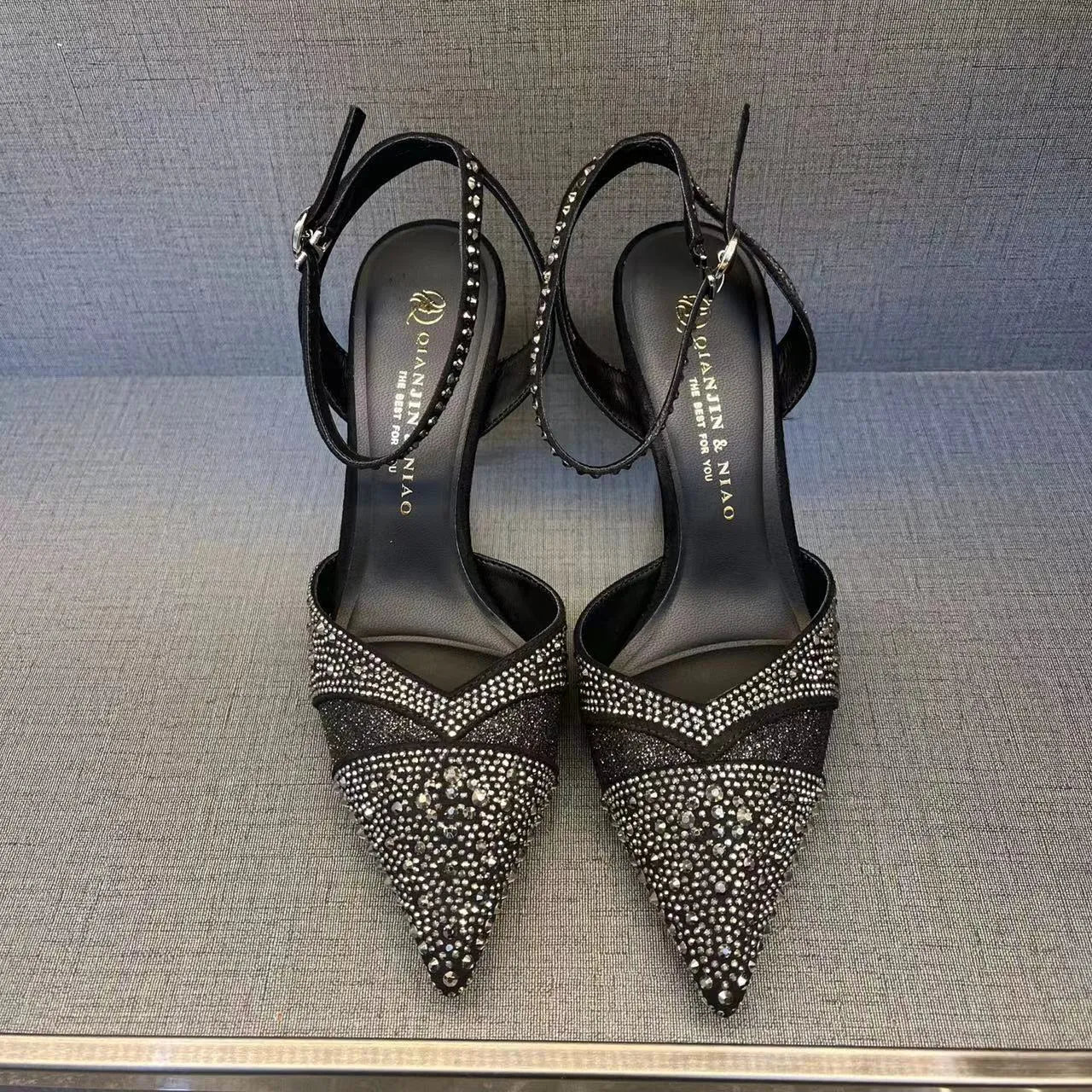 Women's black hollow high heels with red sole and pointed toe stiletto design