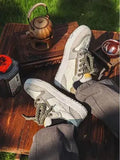 Green low-top casual trainers with star pattern stitching and lace-up closure