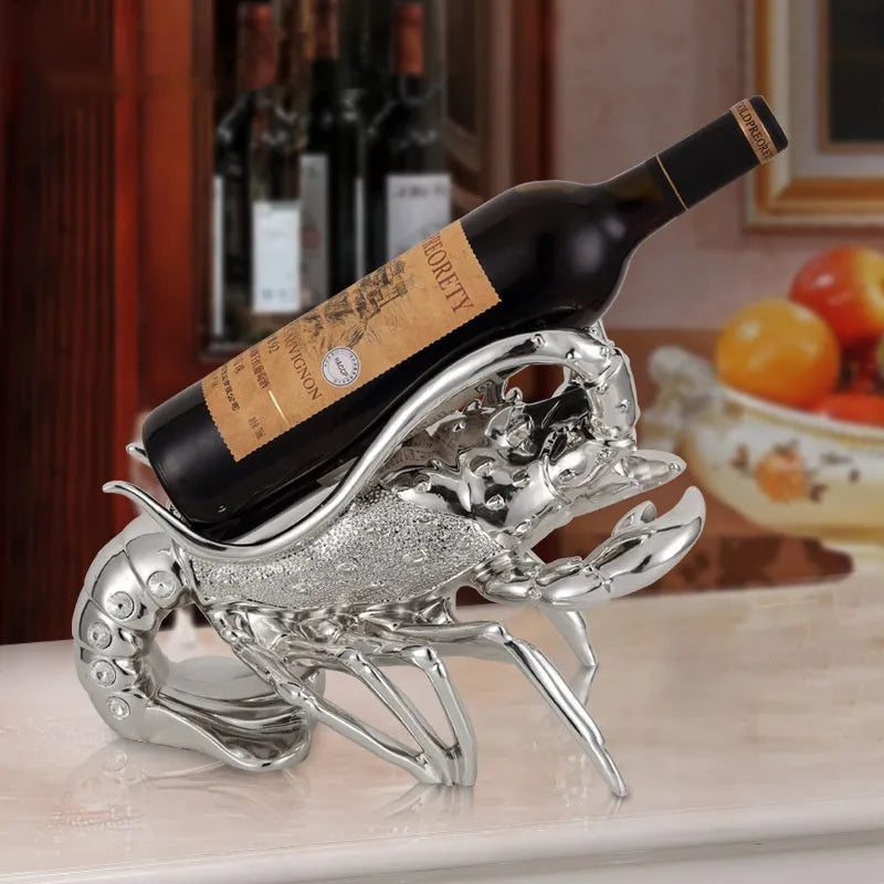Lobster wine rack ornament in rose gold or silver metallic finish holding bottle