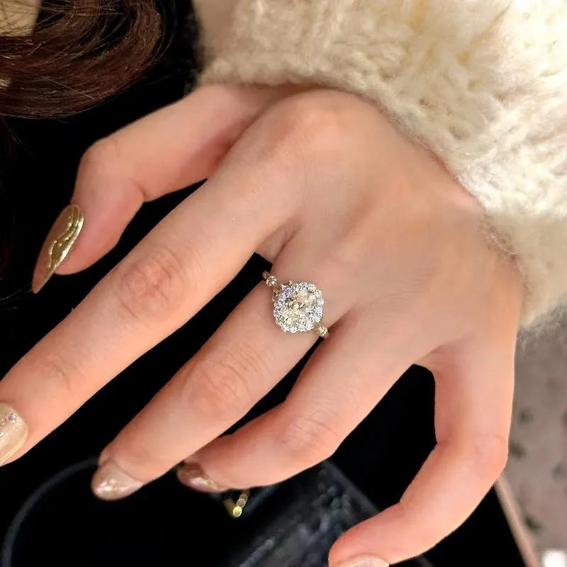 Silver geometric women's ring with large diamond bouquet detail and adjustable opening.