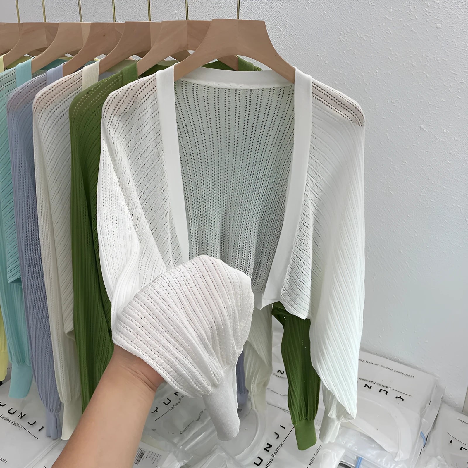 Women's hollow thin loose blouse with lantern sleeves in apricot colour showing slim fit and hollow-out detailing