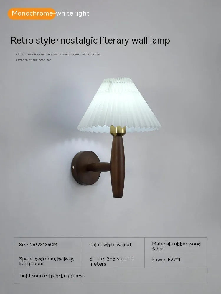American Retro style wooden wall lamp with copper accents and a white fabric shade mounted above a bedside table.