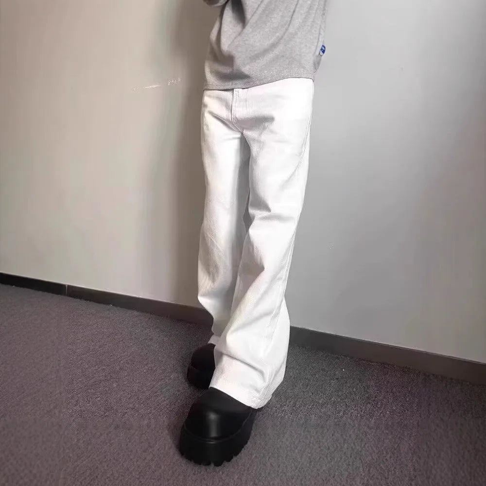 Men's white straight-leg denim jeans with a wide leg opening and a zip fly.