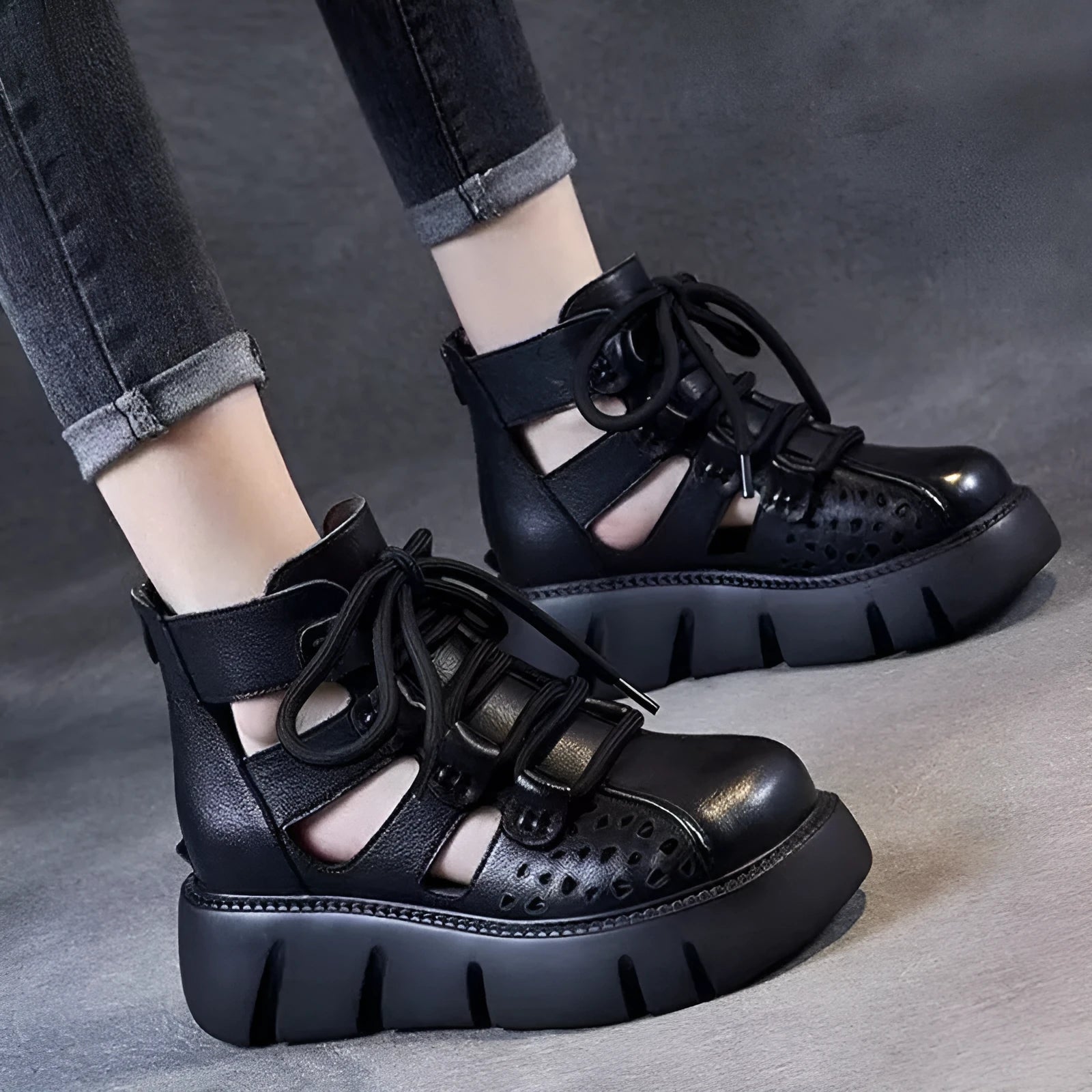 Women's black platform sandals with hollow hole design and fish mouth toe, made from soft leather.