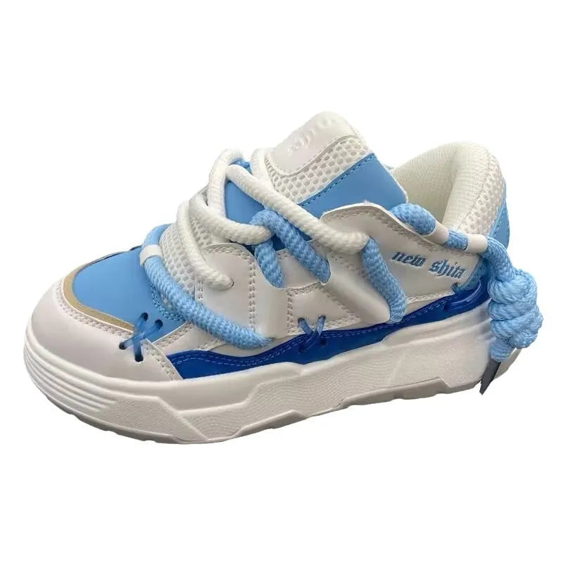 Women's grey retro clunky sneakers with thick rubber platform sole and lace-up front.