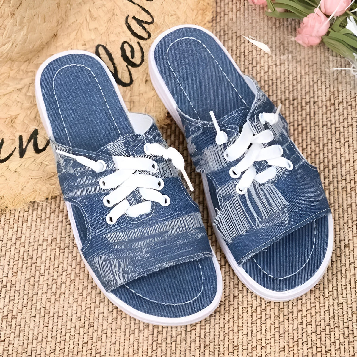 Blue Roman style women's canvas slippers with rubber sole and cloth lining displayed flat