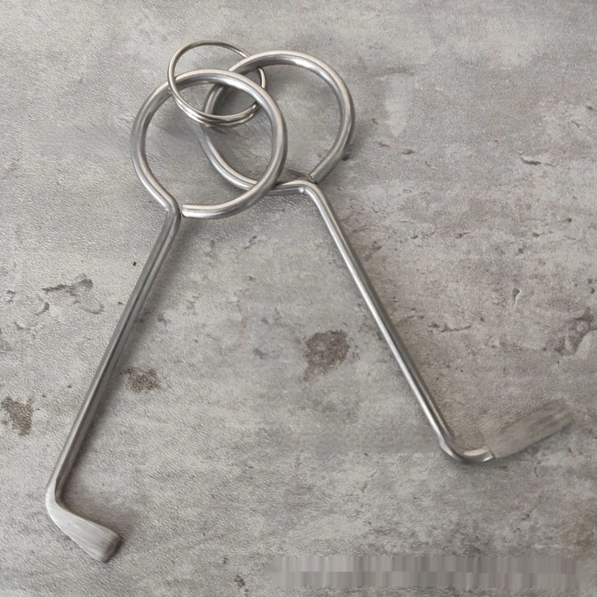 Two metal alloy wrench tools from a portable 2-piece set for household and vehicle maintenance.