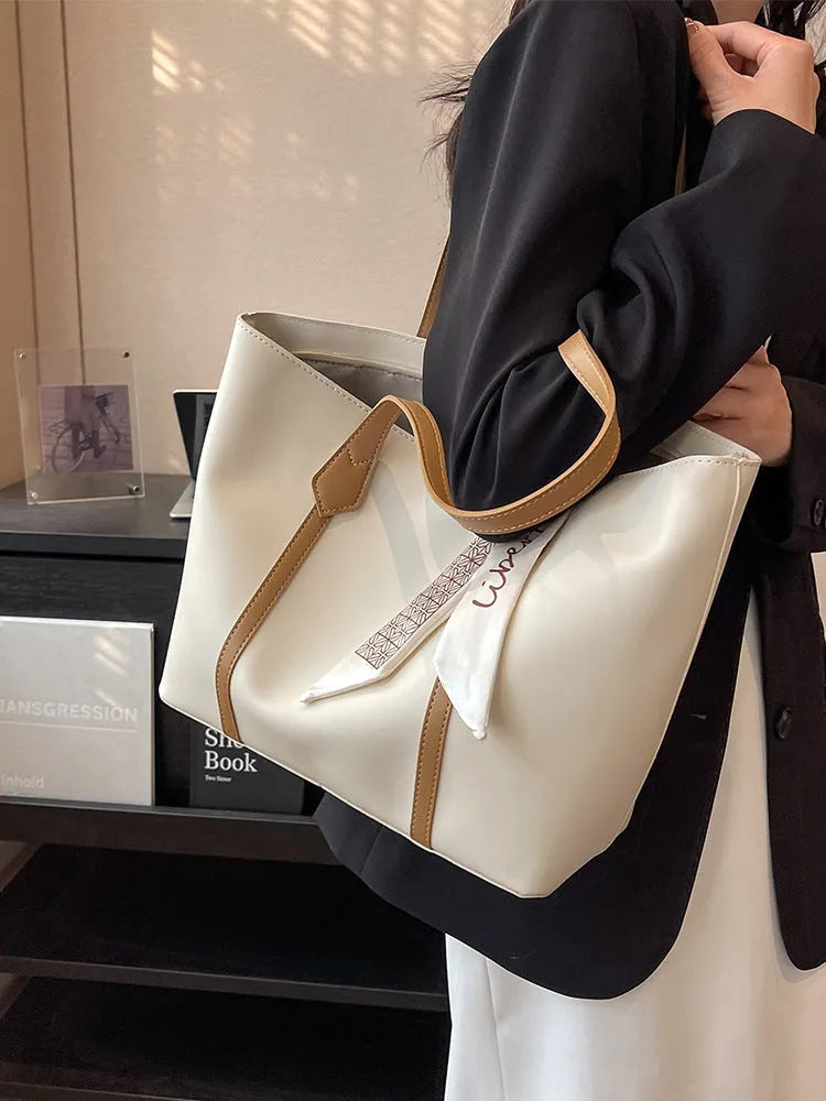 Women's casual tote bag with bucket design showing shoulder strap and crossbody carrying option
