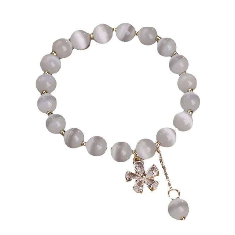 Women's white cat's eye stone bracelet with floral tassel and safety buckle clasp