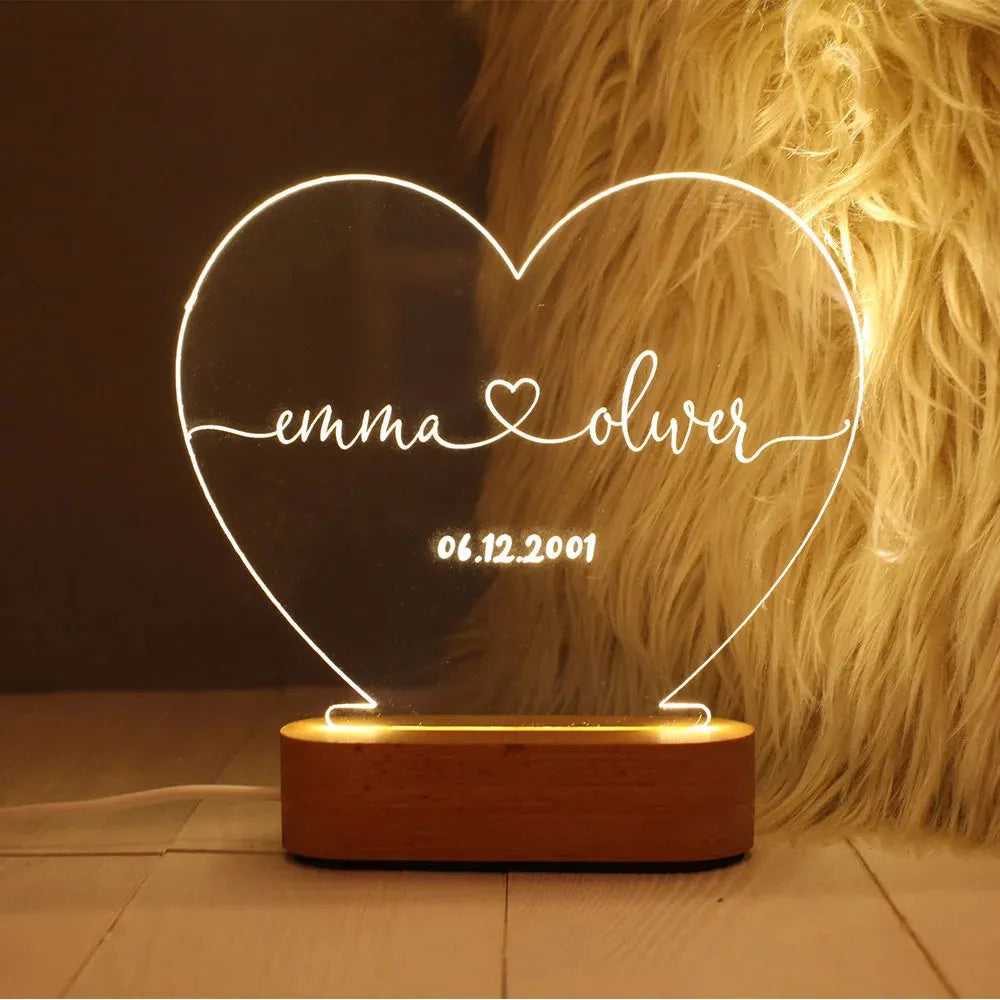 Custom couple names and date engraved on a transparent acrylic LED night light.