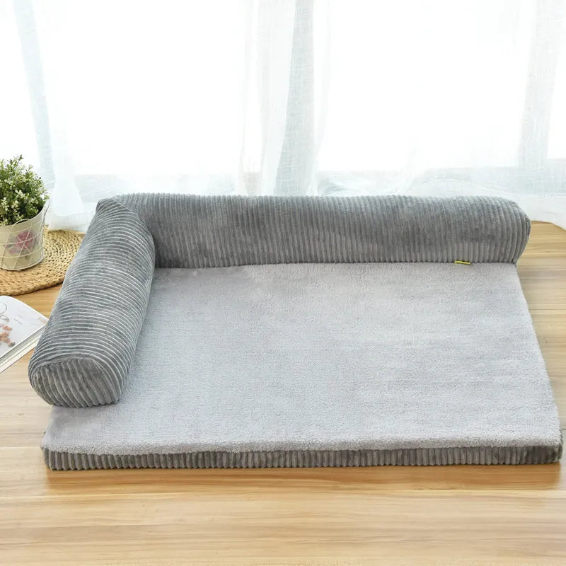 Grey corduroy dog sofa bed with bilateral bolsters on a wooden floor.
