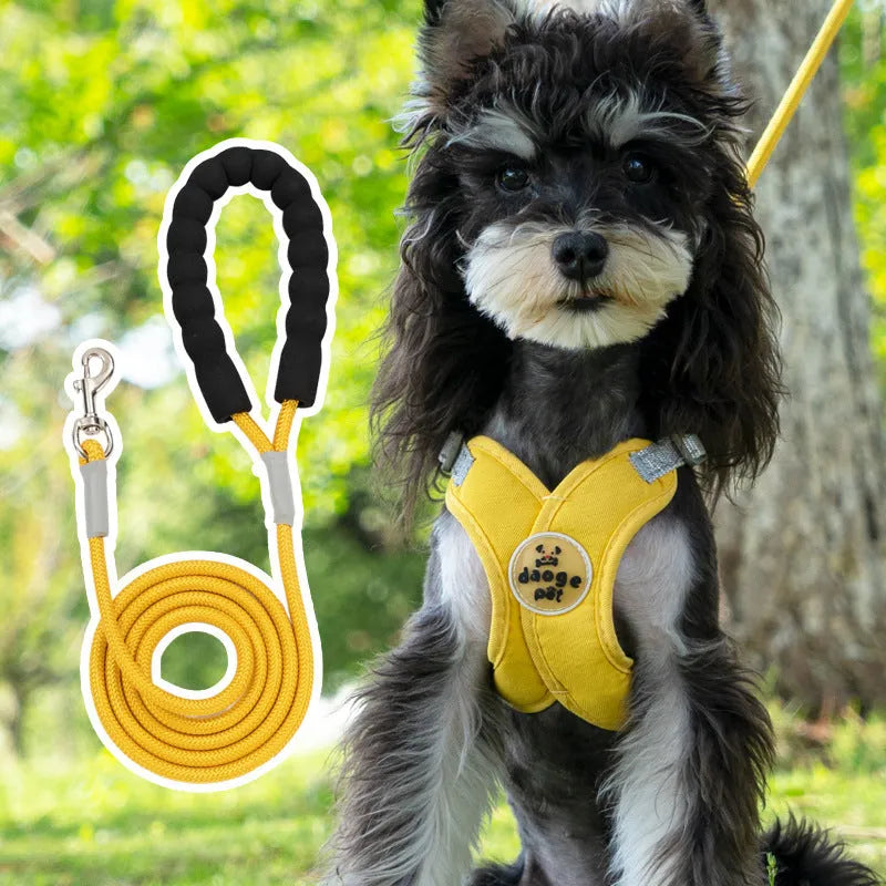 Blue polyester dog vest with an attached hand holding rope laid flat on a white background.