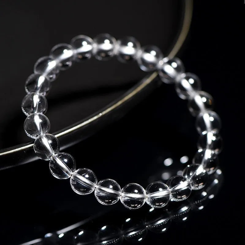 Natural white crystal bead bracelet with round beads on a single strand, geometric unisex design.