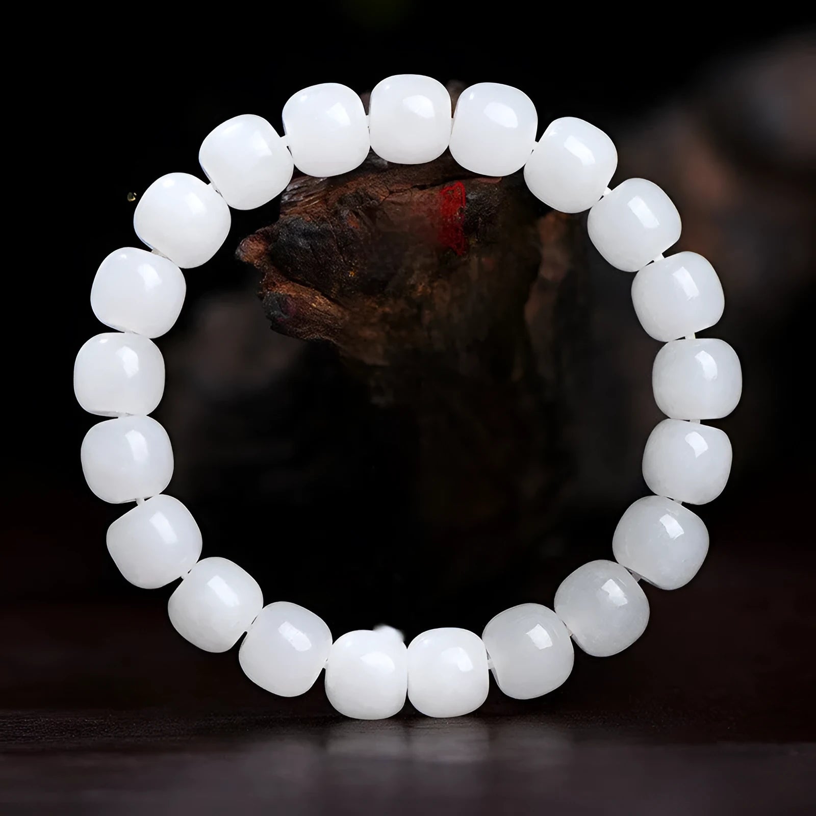 White Hetian jade barrel bead bracelet on a wrist, showing three bead size options.