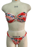 Women's floral print polyester bikini set in blue on a mannequin, showing tube top and briefs.
