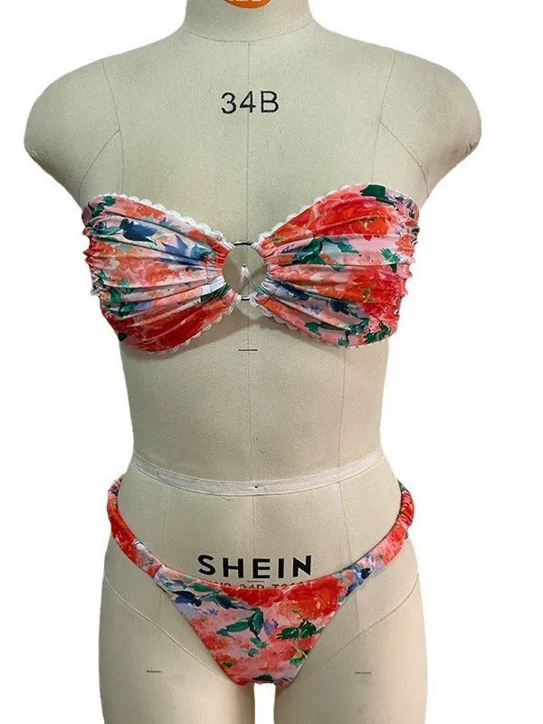Women's floral print polyester bikini set in blue on a mannequin, showing tube top and briefs.