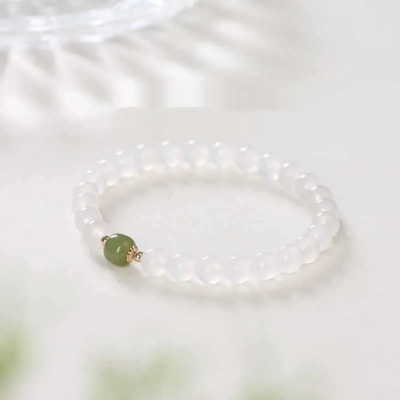 Handmade white agate and cinnabar crystal bracelet showing bead detail and inlay work