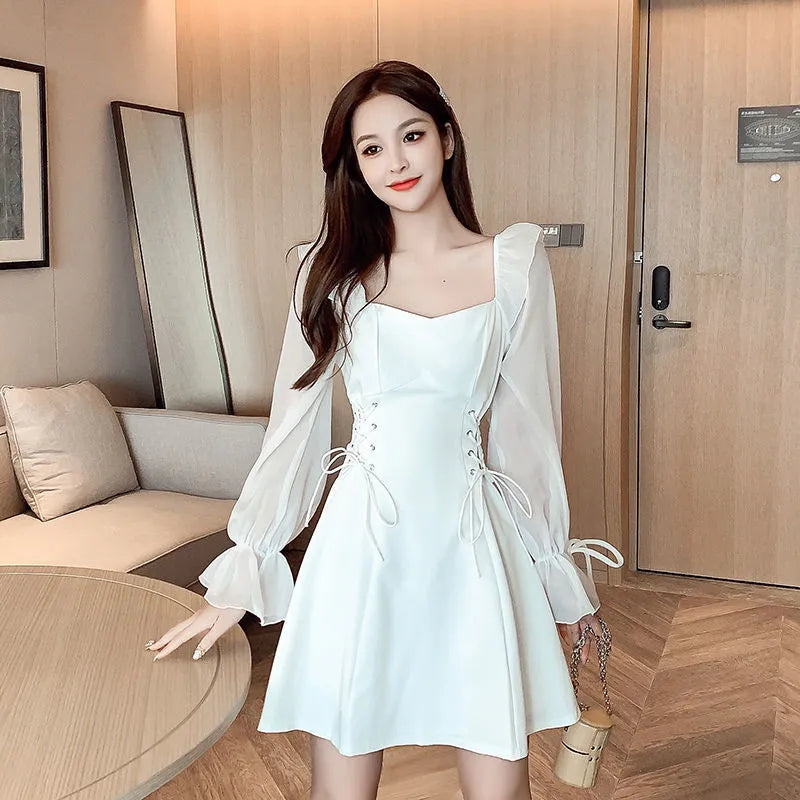 White waist-slimming chiffon patchwork dress with long sleeves on a woman