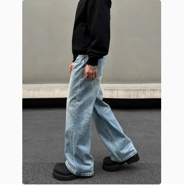 Men's blue retro straight-leg jeans with whisker washing detail on the thighs, showing a flared wide-leg cut.