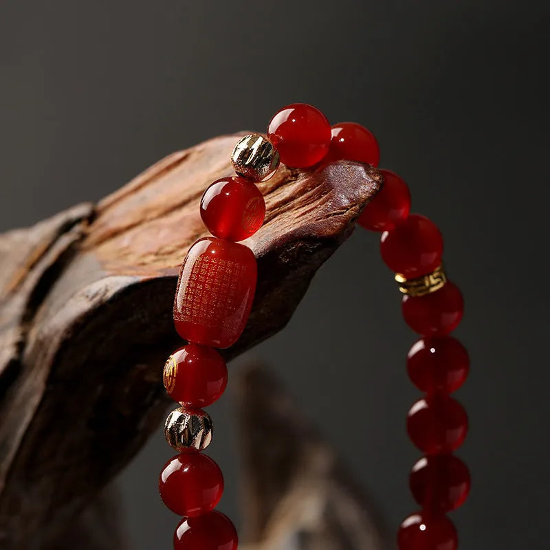 Adjustable unisex Guanyin agate bracelet with auspicious patterns, shown in green and red stone options.