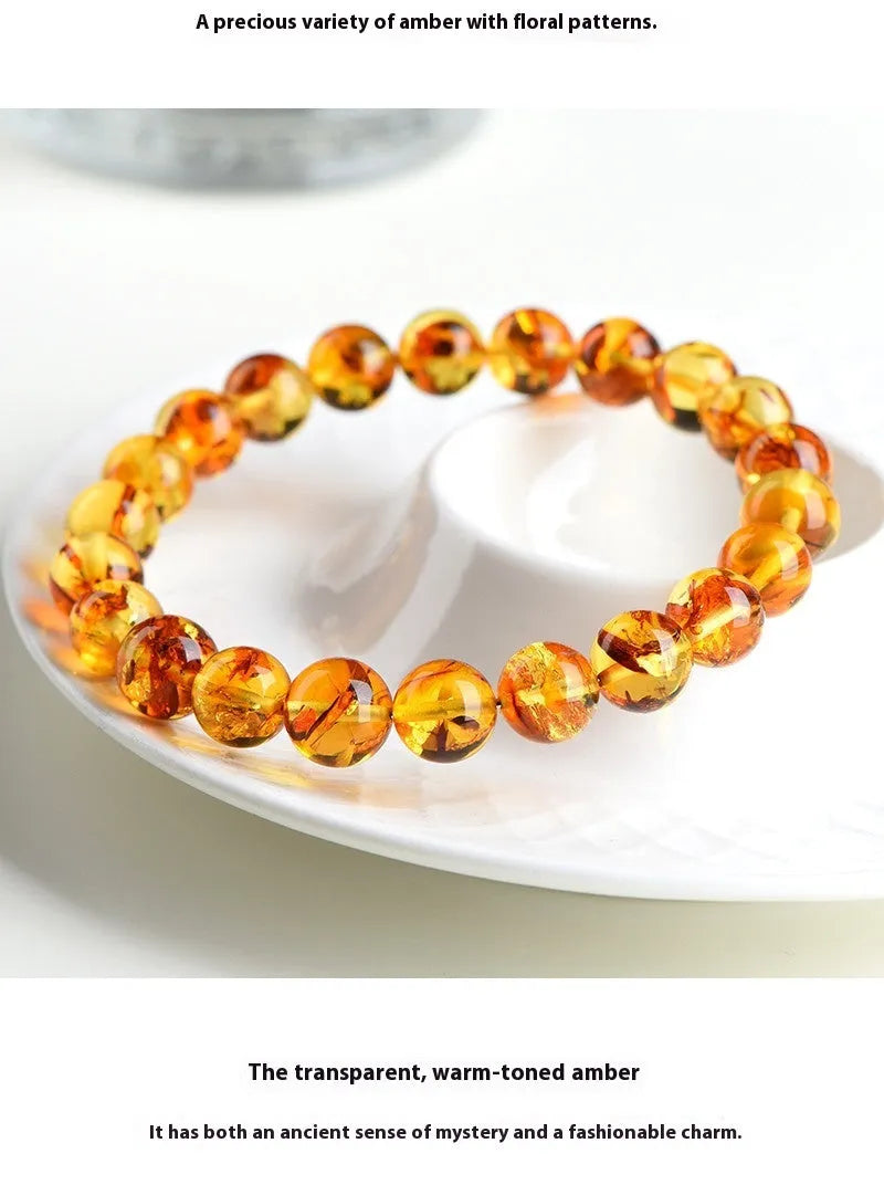 Natural yellow piebald amber bracelet with polished geometric beads on a wrist.