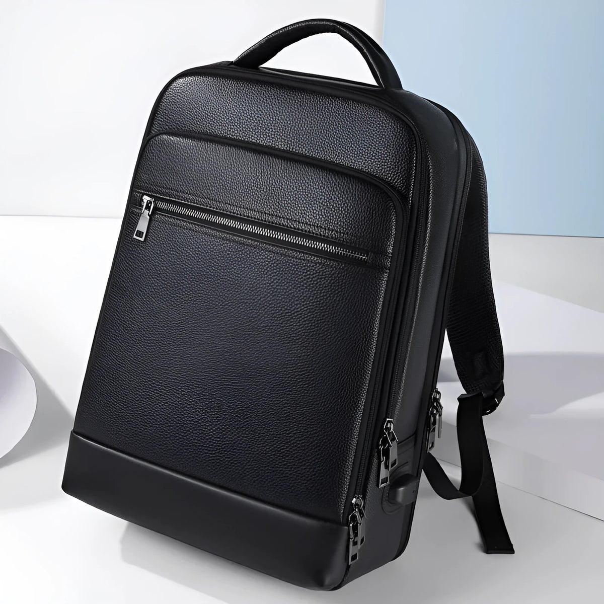 Black leather men's business backpack with curved shoulder straps and visible sewing lines