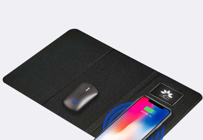 Folding wireless charging mouse pad set with separate Bluetooth mouse on a desk.