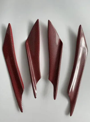 Set of four carbon fibre pattern ABS plastic bumper blades for car modification.